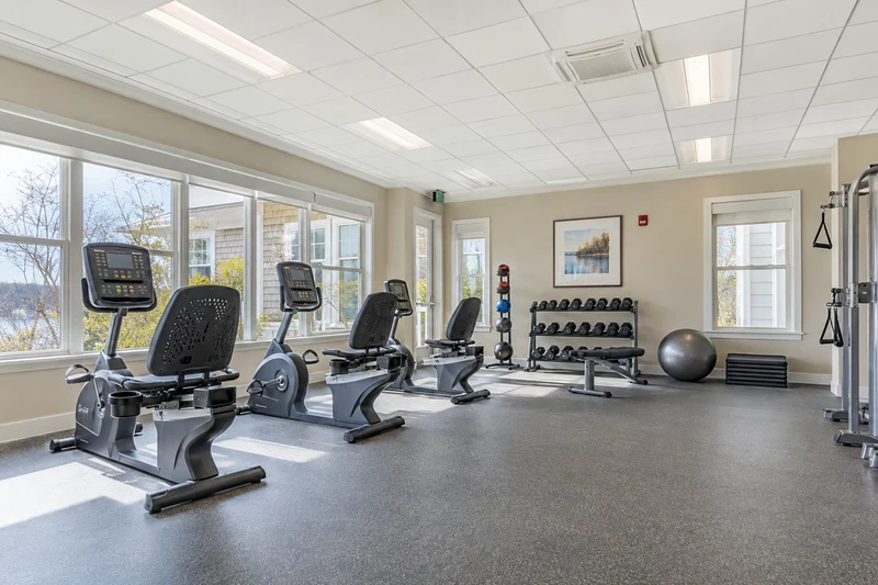 Senior community fitness studio with recumbent bikes and light weights